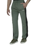 Person wearing green pants and white shoes on a plain background